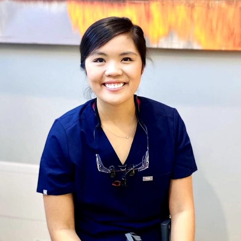 Smiling dental hygienist wearing magnifying loupes